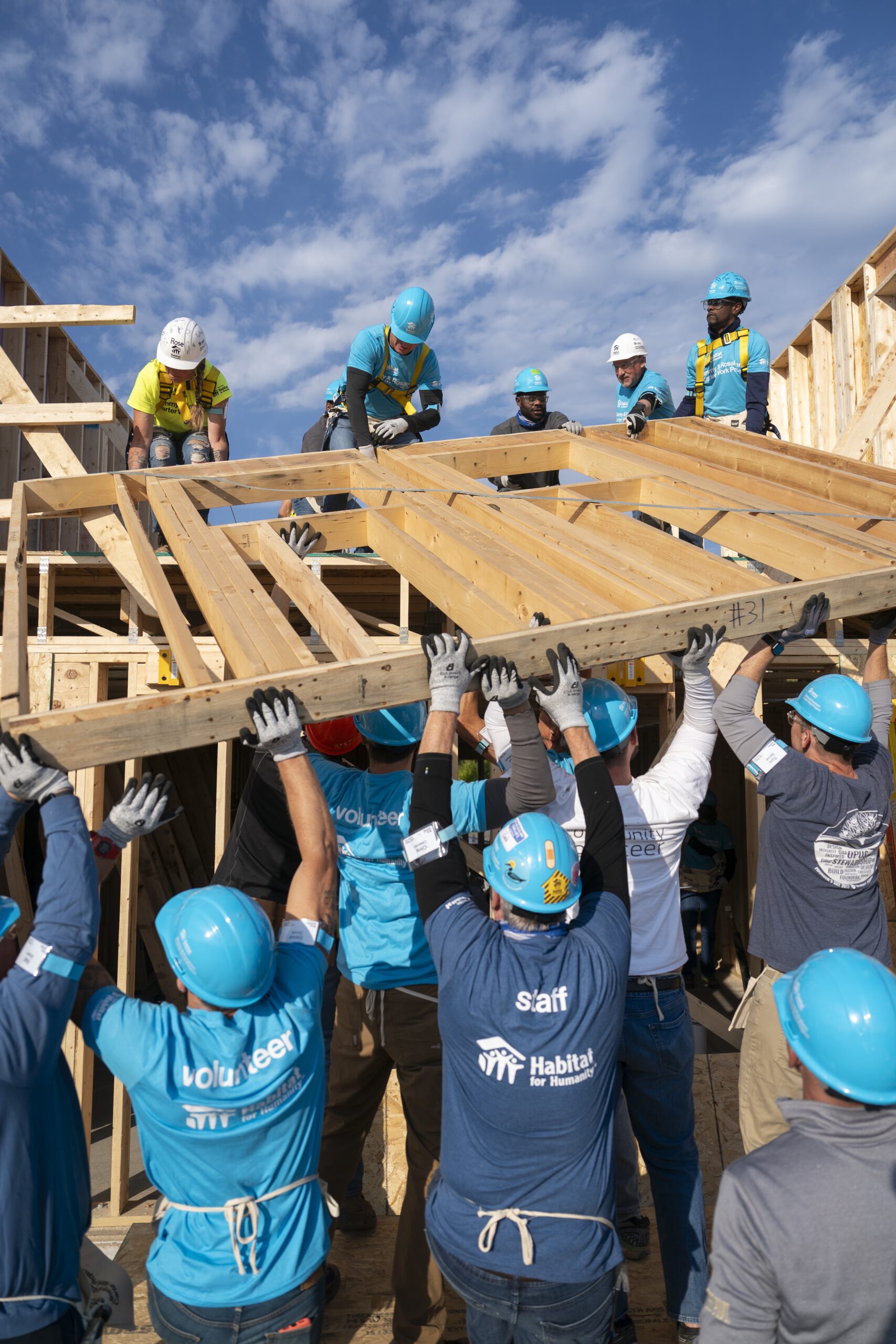 Habitat for Humanity volunteers moving a wall